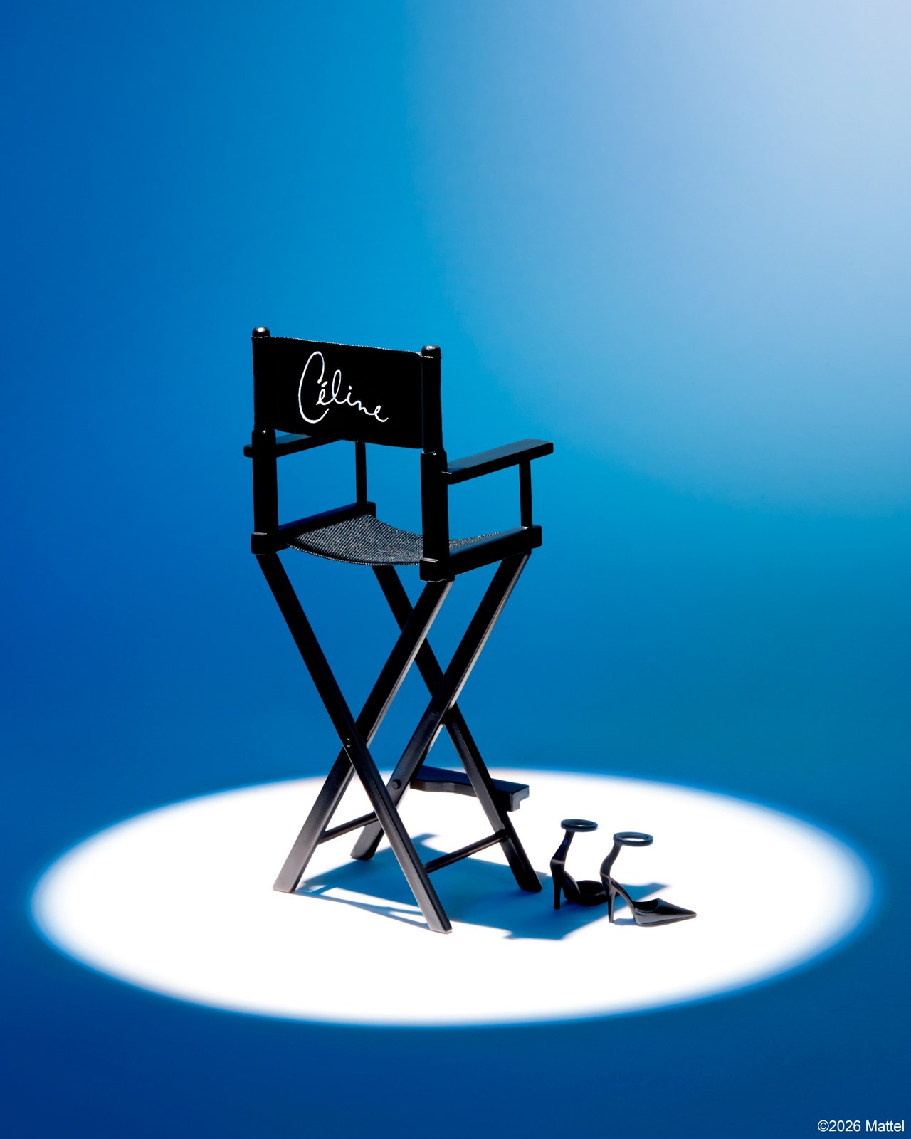 A miniature director's chair with Celine's name in a spotlight