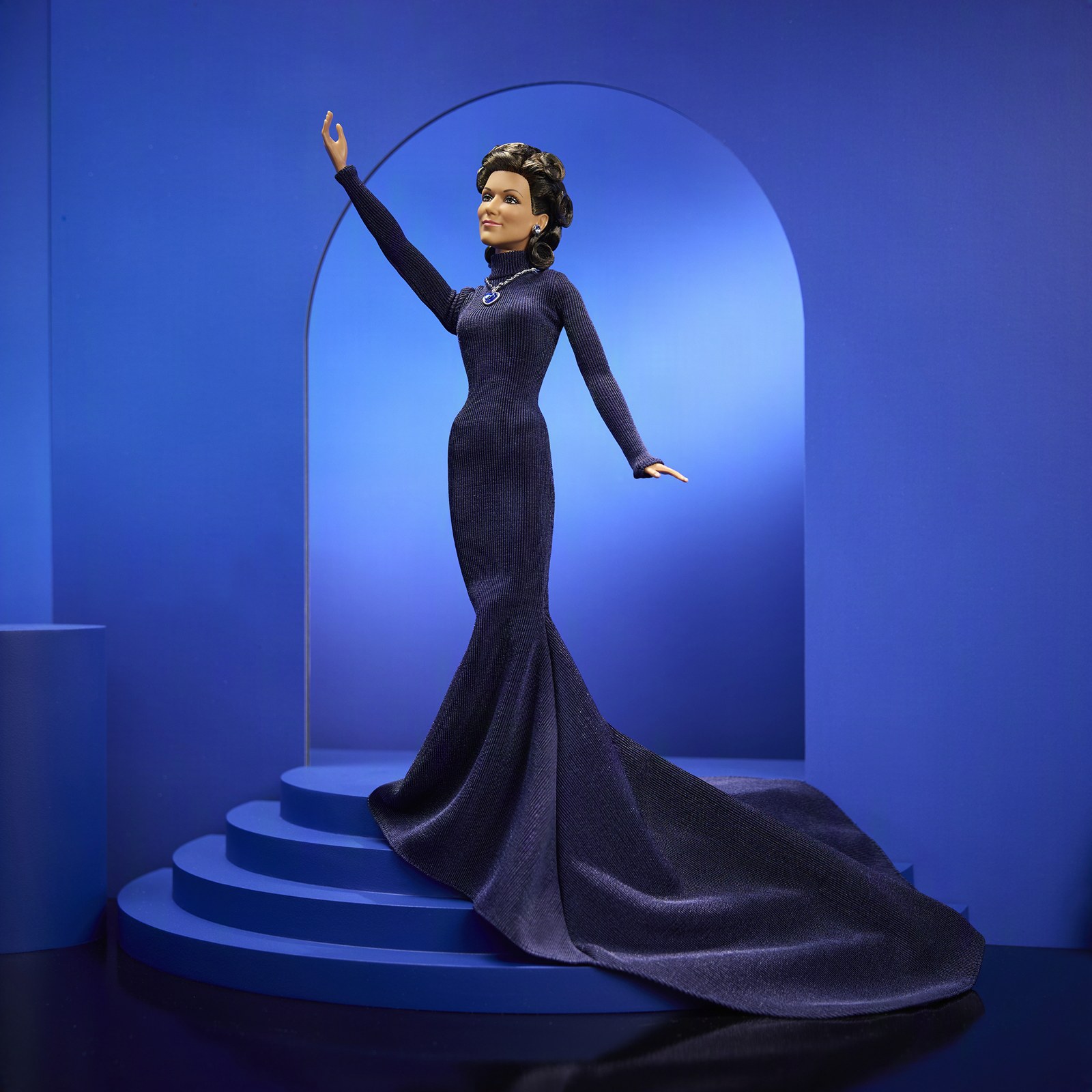 Celine Dion Barbie doll posed with one arm raised, train flowing down the steps