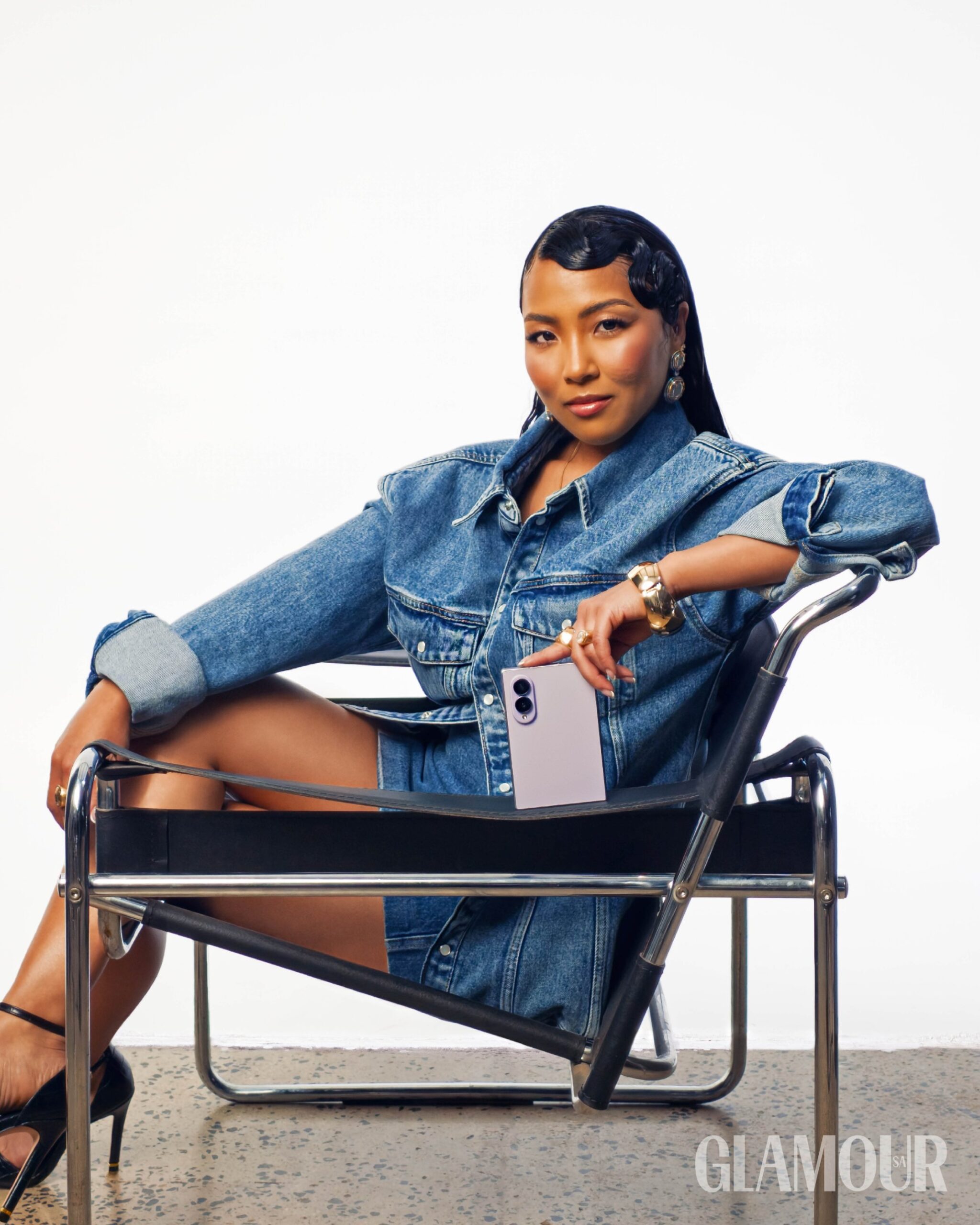 Chanley Wong in oversized denim holding the Samsung Galaxy Z Fold8 Ultra