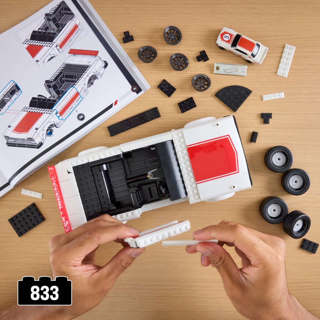 Hands building the Mattel Brick Shop 1971 Nissan Skyline 2000GT-R with the 833-piece set laid out